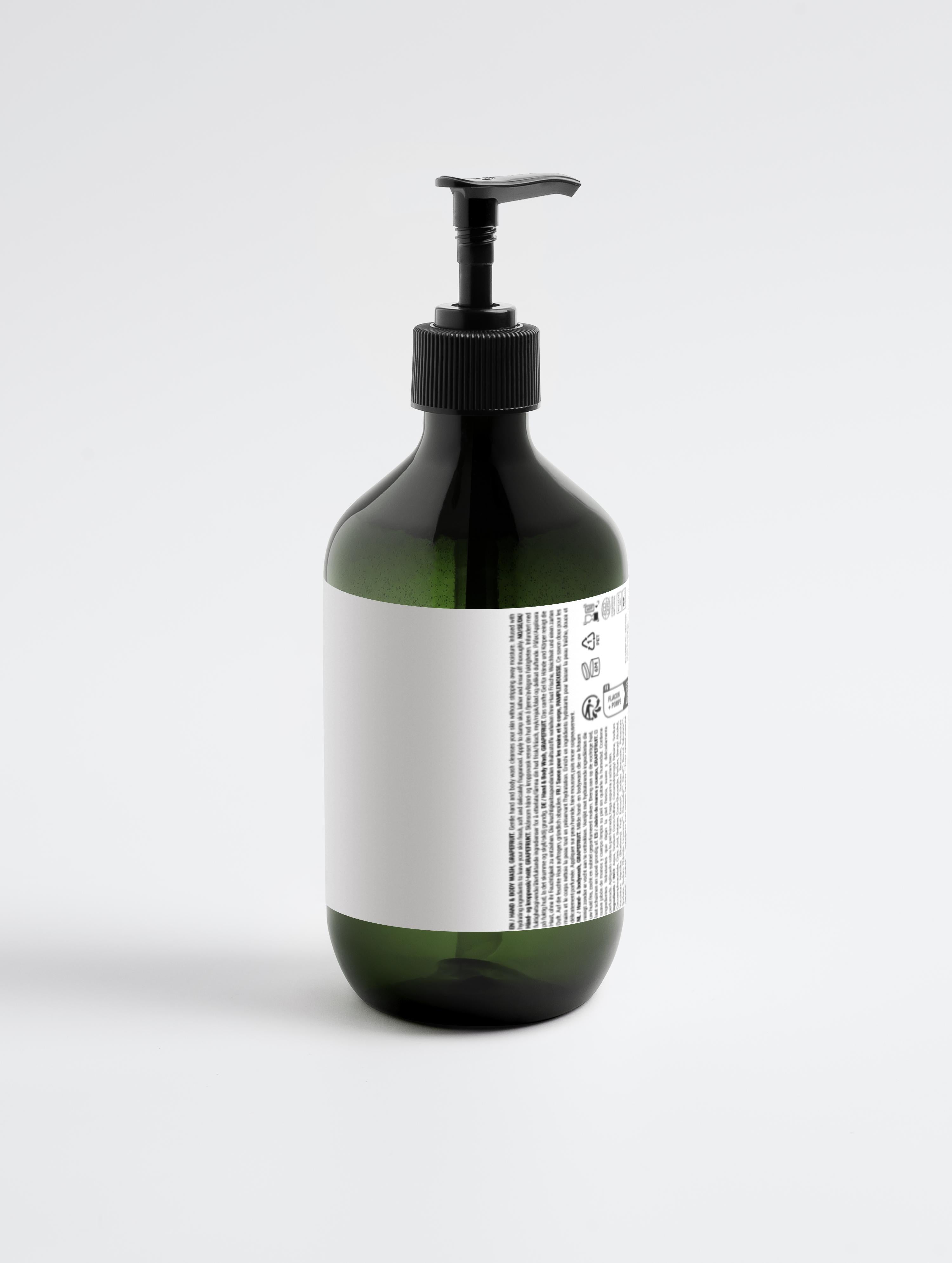Grüne Kunststoffflasche mit schwarzem Pumpverschluss und weißem Etikett mit kleingedrucktem Text;